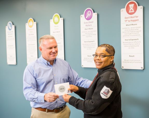 manager giving a thank you card to a security guard