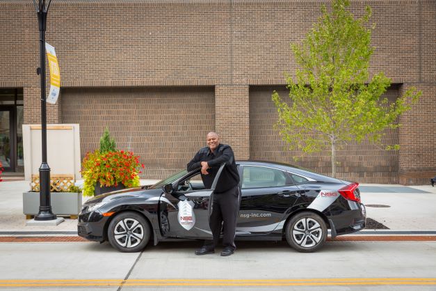 security guard standing with patrol car