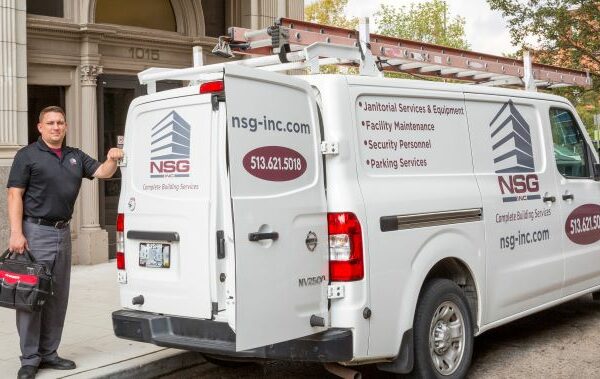 maintenance employee standing with maintenance van