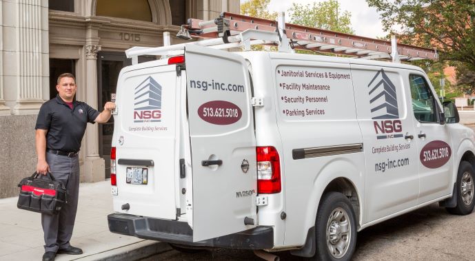 maintenance employee standing with maintenance van