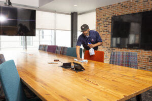 janitorial service cleaning an office conference room