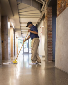 commercial cleaner mopping office hallway floors