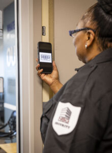 Apartment security guard making a foot patrol tour and scanning barcode for enhanced accountability tracking