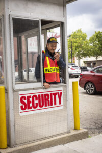 parking lot security guard monitoring lot entry/ exit