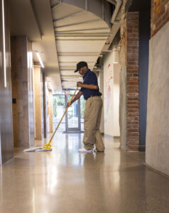 Janitorial services mopping hallway floor