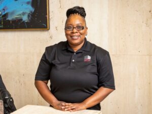 Security Guard at reception desk smiling
