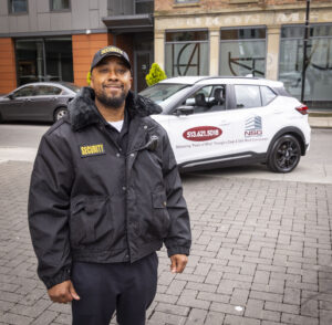 security guard standing in front of patrol car