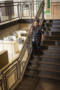 Security guard on walkie talkie, walking property