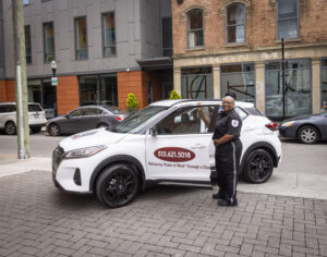 security guard standing next to patrol car