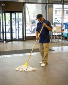 medical office commercial cleaning staff mopping floor of medical office lobby