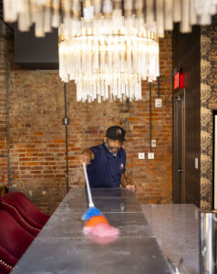 NSG employee dusting surface during a post construction cleaning